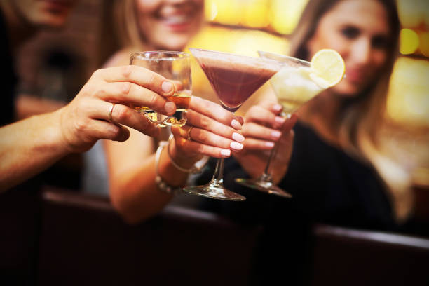 istock Group Of Friends Enjoying Drink in Bar 887315922