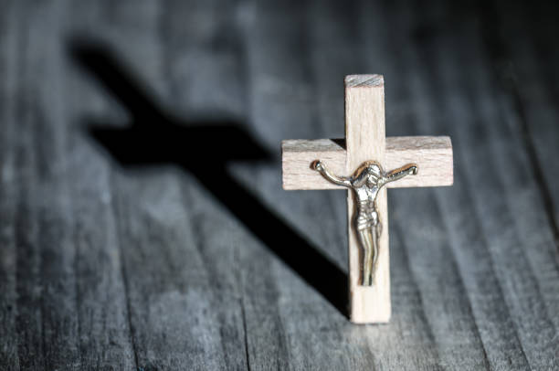 istock wooden cross with shadow 887318020