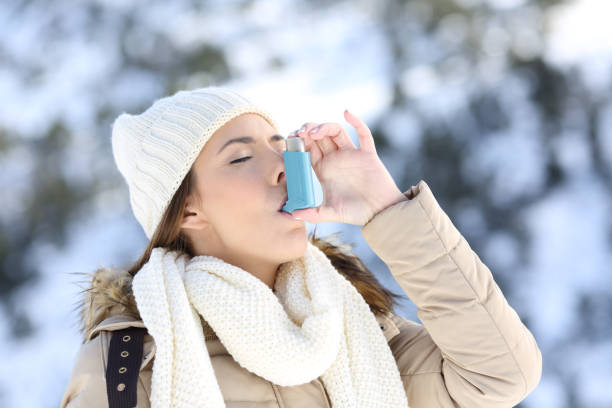 寒い冬に喘息の吸入器を使用しての女性 - winter women snow mountain ストックフォトと画像