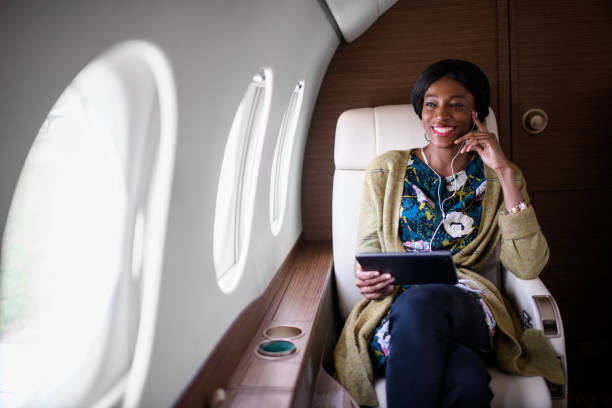 istock Woman in private jet airplane 887318686