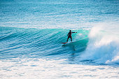 Surfer ride on blue wave. Winter surfing in ocean