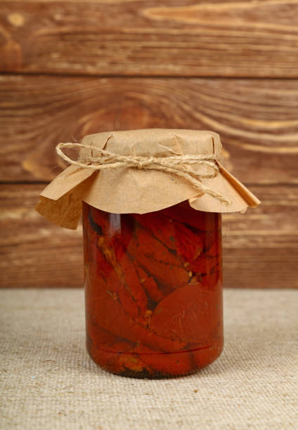 istock Jar of pickled sundried tomatoes on table 887322480