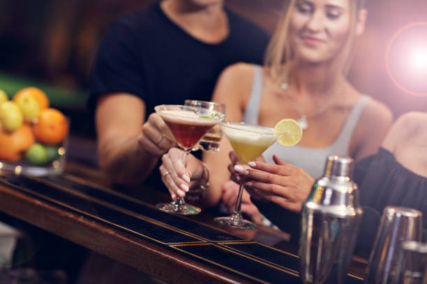istock Group Of Friends Enjoying Drink in Bar 887323110