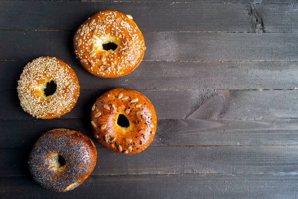 istock Bagels with seeds on a black background. 887330444