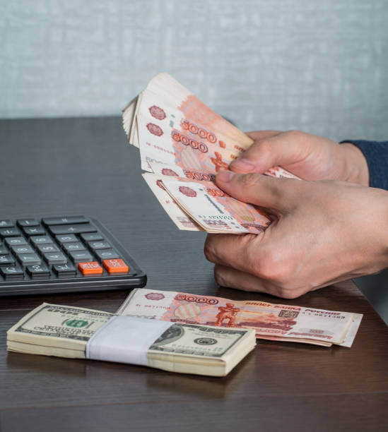 istock Man's hands with money and calculator 887330454