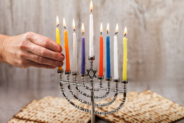 istock Menorah with candles for Hanukkah on a light wooden background 887340944