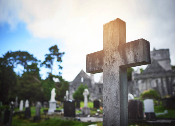 White stone cross in a graveyard in Andalsnes, Norway.