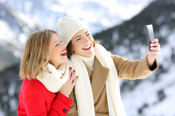 istock Friends taking selfies in a snowy mountain 887347410