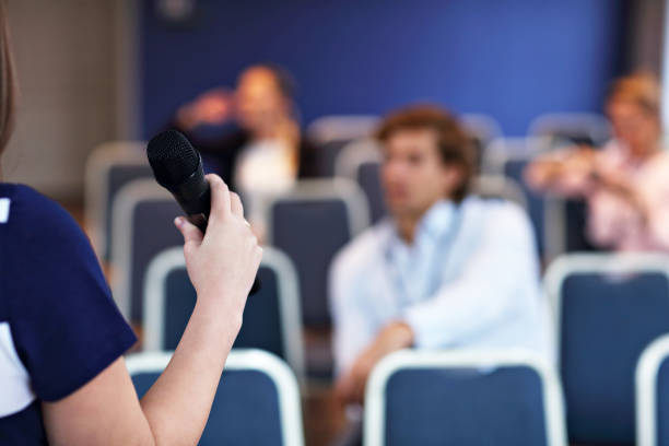 istock Young bored people sitting in conference room 887354824