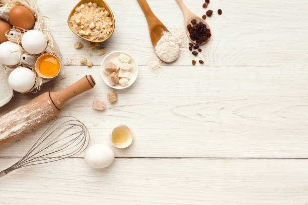 istock Baking background with eggs and flour on white rustic wood 887357554