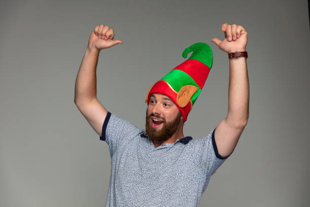 istock Happy bearded guy with Christmas Elf hat 887357812