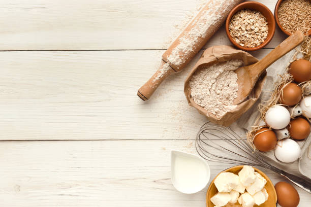 istock Baking background with eggs and flour on white rustic wood 887357816