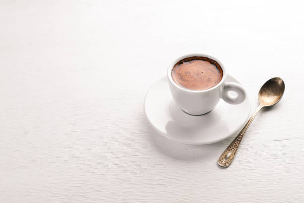 istock Espresso coffee cup on a white wooden background. Top view. Free space for text. 887358468