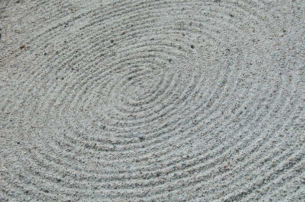istock Zen circle shape white sand rock garden floor 887358486