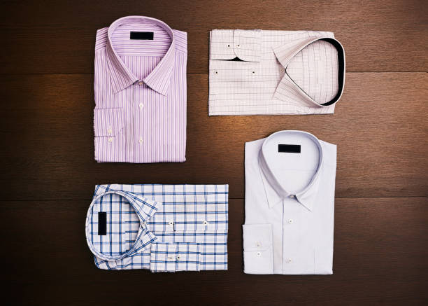Business shirt button down clothing stacked in a pile