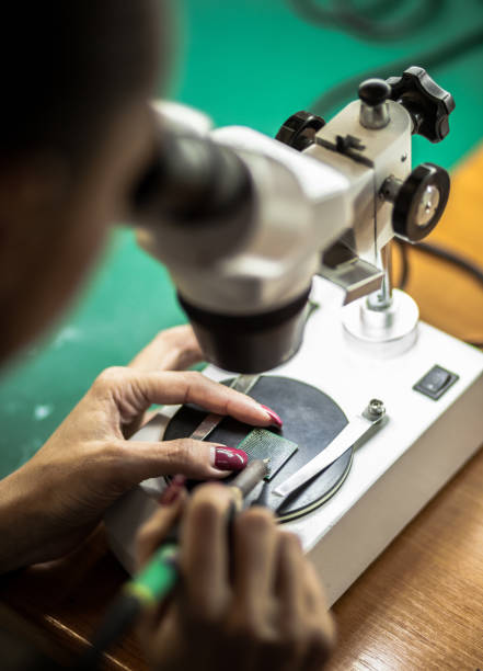 istock Woman Soldering a circuit board in her tech office 887360898