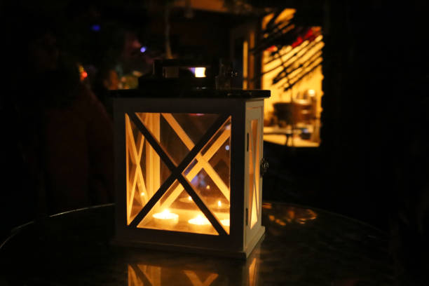 istock Wooden candle latern on table in city. 887361800