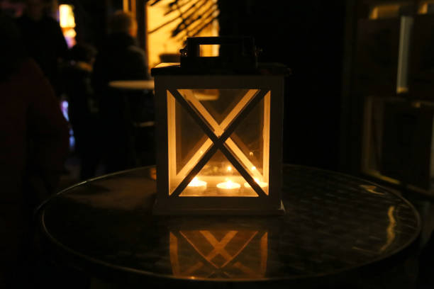 istock Wooden candle latern on table in city. 887362064