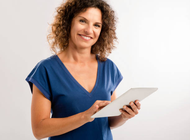 istock Happy woman working with a tablet 887362940