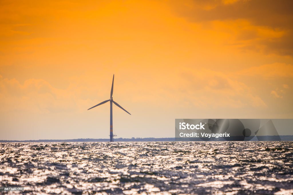 Wind turbines farm in Baltic Sea, Denmark Wind turbines generator farm for renewable sustainable and alternative energy production along coast baltic sea near Denmark. Eco power, ecology. Axis Powers Stock Photo