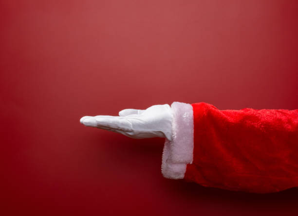 istock Santa Claus open his hand on red background 887365774