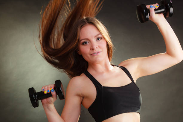 istock Fit woman exercising with dumbbells. 887366184