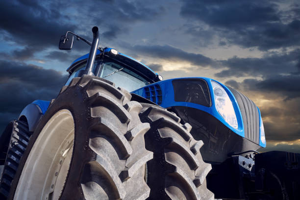 Powerful tractor on sunset background stock photo