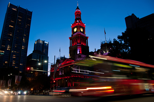 Light moving of bustling city center scene with old clock tower in Sydney