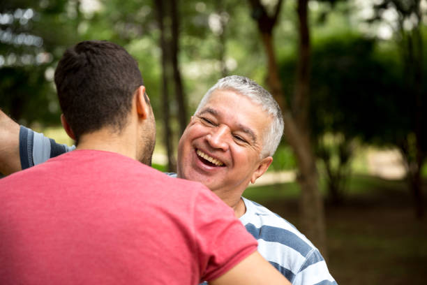 Happy Mixed Race Chinese Boy Riding Piggyback on Shoulders of Caucasian Father Isolated on White.