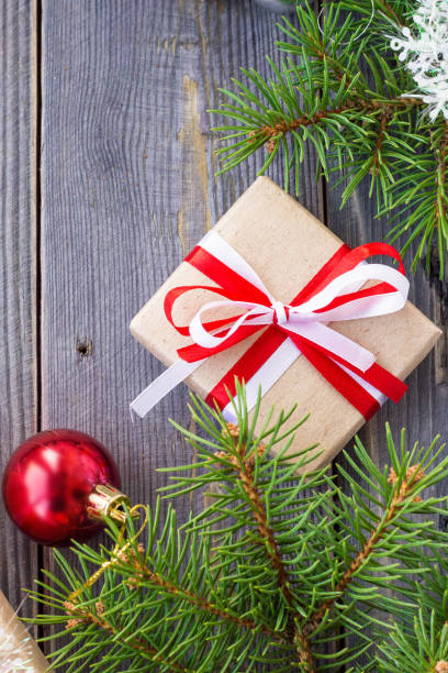 istock Christmas background with fir tree and decorations and gift boxes on wooden board 887367302