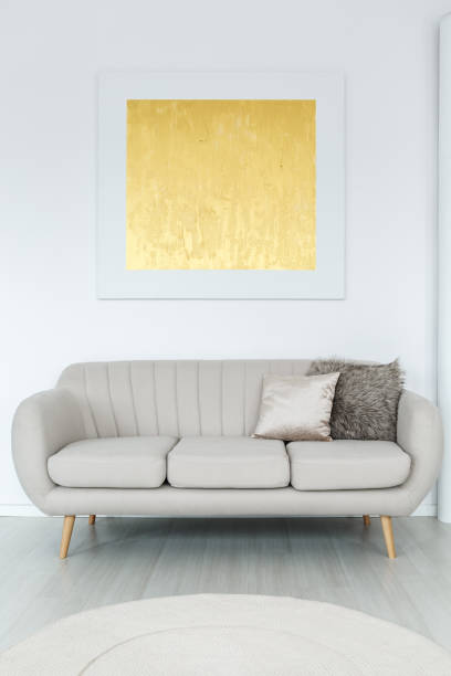 istock Gold poster above couch 887375760