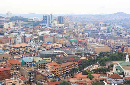 Kampala, Uganda – October 30, 2017: View of Kampala from the minaret of the National Mosque at Kampala Hill. Kampala (a contraction of local language words for the hill or the place of the impala) is the capital and largest city of Uganda, a fast growing African city with a population of about 2 million people. The Uganda National Mosque is a mosque located at Kampala Hill in the Old Kampala area. It was completed in 2006 and it seats over 15,000 worshipers. It is also known as the Gaddafi Mosque because it was a present from the late Libyan leader.