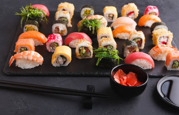 istock Sushi and rolls background, japanese cuisine 887380046