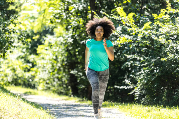 istock African woman jogging in park 887382510