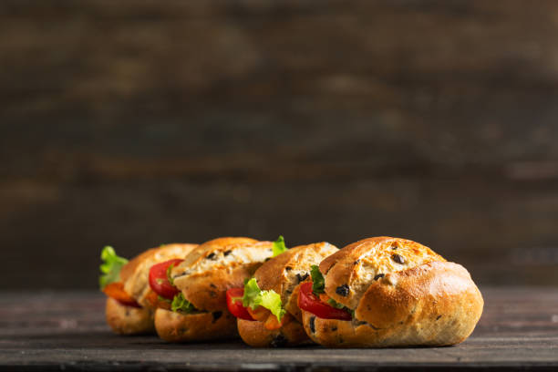 Delicious Mini Sandwiches with Olive Bread on Rustic Table