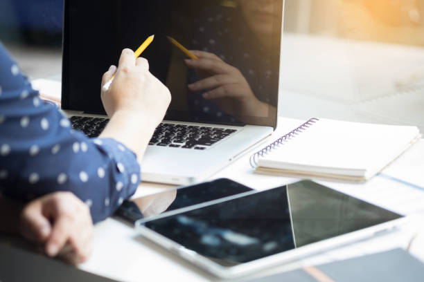 istock Businesswoman Using Laptop At Table In Office 887383370