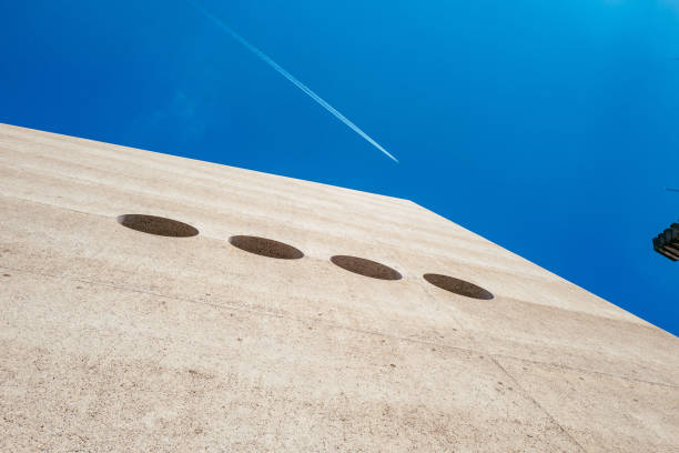 istock Low Angle View Of Building Against Blue Sky During Sunny Day 887384218