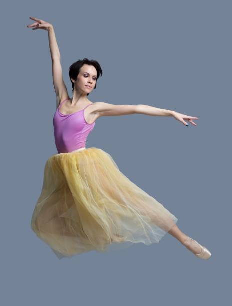 istock ballerina is dancing in the studio on a gray background 887388690