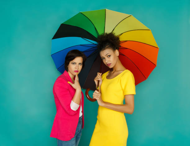 istock Two worried girlfriends posing at turquoise studio background 887388754