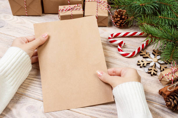 istock Child write letters and holds them in hands. Mock-up letter format A4 887388930