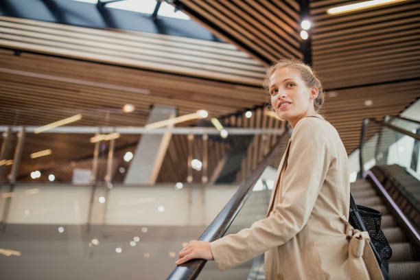 istock Young Woman on Escalator 887389300