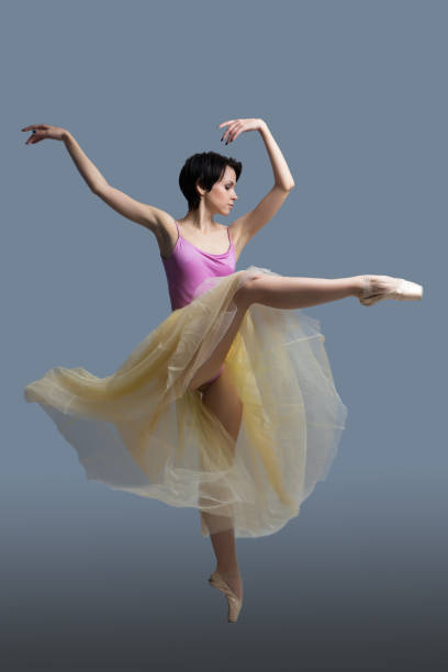 istock ballerina is dancing in the studio on a gray background 887389428