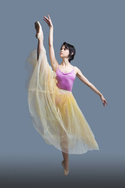 istock ballerina is dancing in the studio on a gray background 887389514
