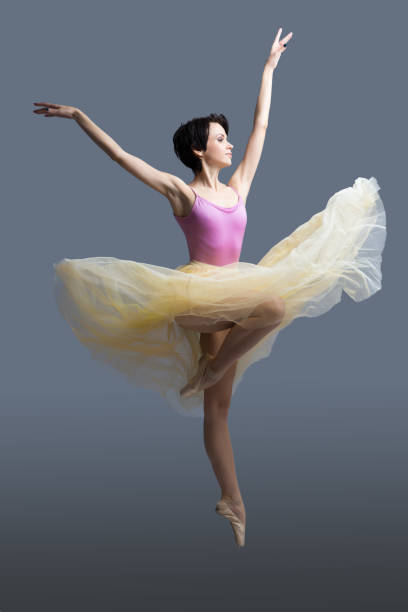 istock ballerina is dancing in the studio on a gray background 887389612