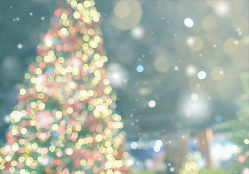 Christmas and New Year concept. Blurred Christmas tree with decorations blurred from the celebration. Can be used for display or montage your products.