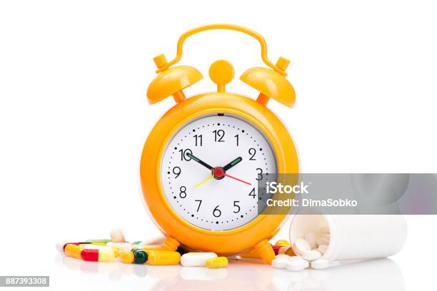 Orange Alarm Clock And Medical Pills Stock Photo - Download Image Now - Addiction, Alarm, Antibiotic