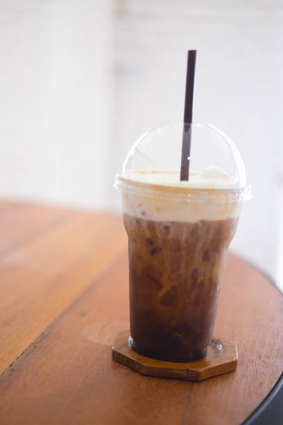 istock Glass with cold brew coffee and milk on wooden table 887394536