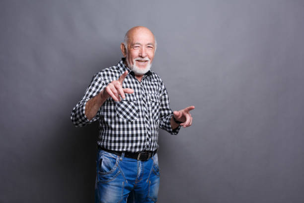 istock Confident senior man point away 887395744