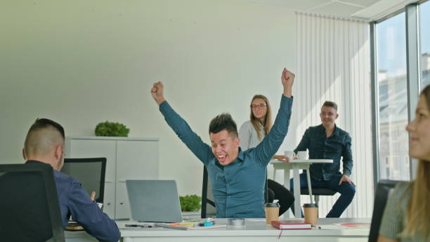 istock Businessman Celebrating Victory Looking at Laptop 887411326