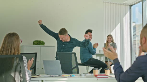 istock Businessman Celebrating Victory Looking at Laptop 887411666